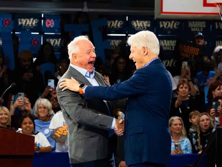 Minnesota Gov. Tim Walz (D) speaks at a rally in Durham, N.C., for the first day of early voting, accompanied by former president Bill Clinton, right. MUST CREDIT: Cornell Watson for The Washington Post