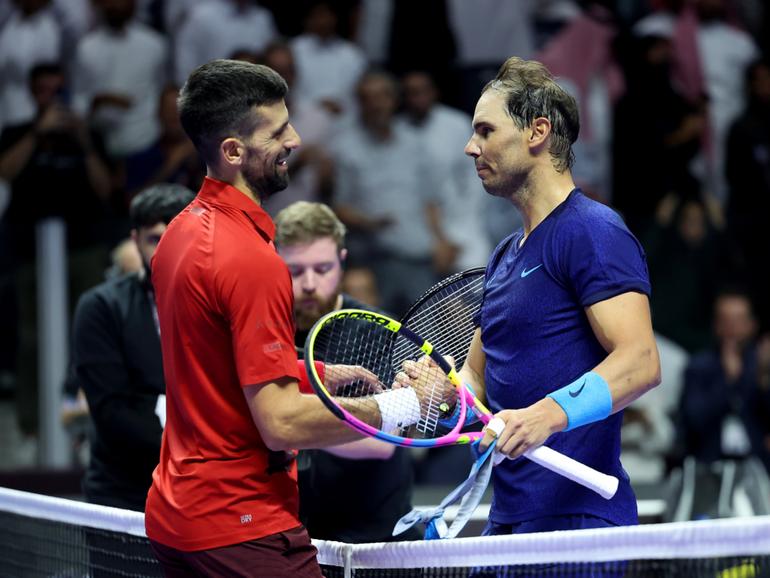 Novak Djokovic and Rafael Nadal shake hands on court one last time.