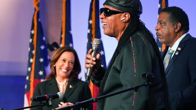 Stevie Wonder performs at Divine Faith Ministries International as Vice President Kamala Harris applauds. Megan Varner