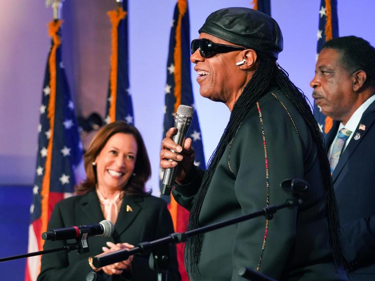 Stevie Wonder performs at Divine Faith Ministries International as Vice President Kamala Harris applauds. Megan Varner