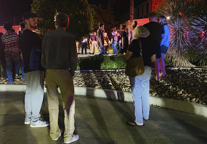 People gather near the site of a helicopter crash Sunday, Oct. 20, 2024, in Houston.