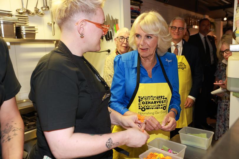 SYDNEY, AUSTRALIA – OCTOBER 22: Queen Camilla helps prepare a meal during her visit to Refettorio OzHarvest Sydney on October 22, 2024 in Sydney, Australia. The Queen and King Charles III's visit to Australia is his first as monarch, and the Commonwealth Heads of Government Meeting (CHOGM) in Samoa will be his first as head of the Commonwealth. (Photo: Ian Vogler-Pool/Getty Images)