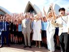 King Charles III and Queen Camilla pose for a photo with students at the Sydney Opera House on October 22, 2024 in Sydney, Australia. 