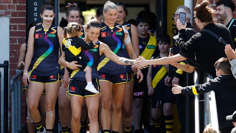 Kate Dempsey and daughter Pippa lead out the Tigers for the Pride round match against Geelong.