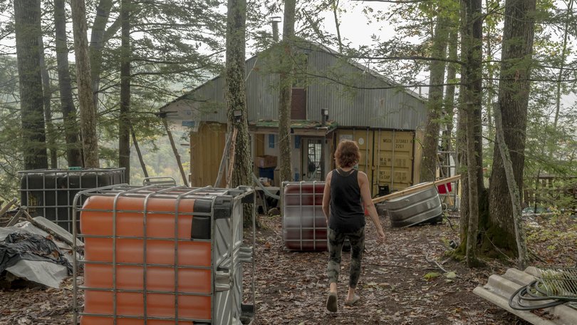 Audra Bogacik wanders around the off-grid camp she and her father built in the woods of Pocahontas County. MUST CREDIT: Emily Kask for The Washington Post