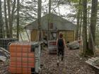 Audra Bogacik wanders around the off-grid camp she and her father built in the woods of Pocahontas County. MUST CREDIT: Emily Kask for The Washington Post