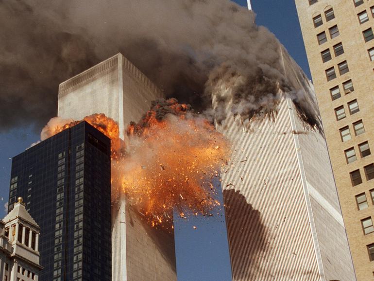 Smoke billows from one of the towers of the World Trade Center and flames and debris explode from the second tower, Tuesday, Sept. 11, 2001. 