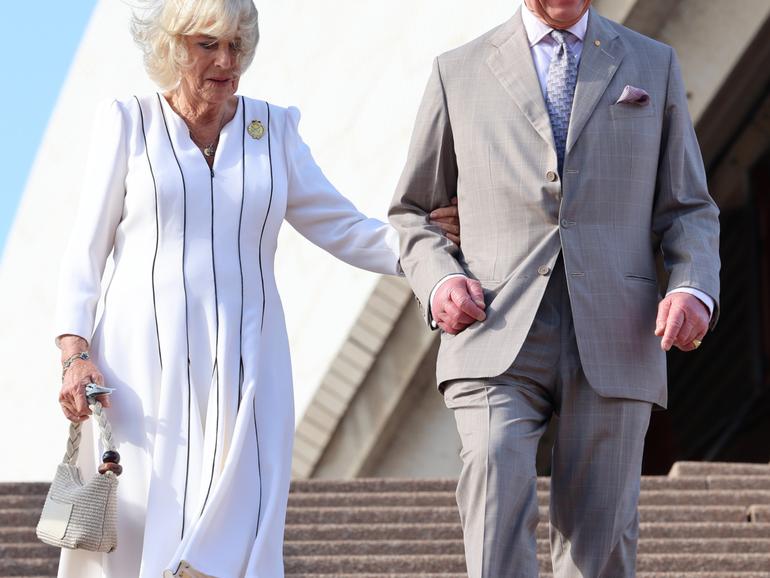 SYDNEY, AUSTRALIA - OCTOBER 22: King Charles III and Queen Camilla walk down the steps at the Sydney Opera House on October 22, 2024 in Sydney, Australia. The King's visit to Australia is his first as monarch, and the Commonwealth Heads of Government Meeting (CHOGM) in Samoa will be his first as head of the Commonwealth. (Photo by Chris Jackson/Getty Images)