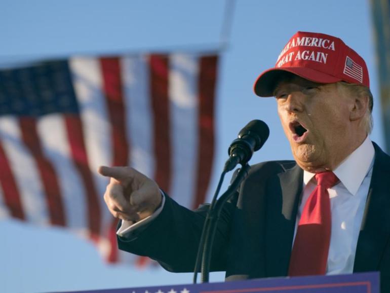 A man was found with guns and ammunition at a security checkpoint near Donald Trump's rally.  (AP PHOTO)