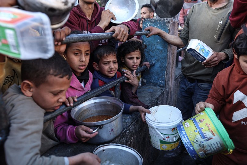 Palestinians line up for food in Rafah, southern Gaza, in March.