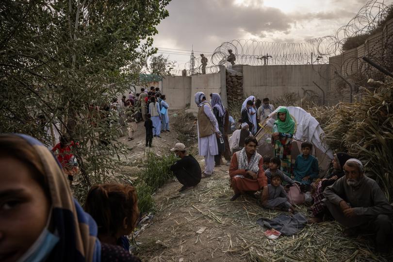 People hoping to flee Afghanistan are gathered outside the Hamid Karzai International Airport in Kabul, Afghanistan, Aug. 22, 2021. 