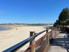 A NSW man has drowned in the surf at a Queensland beach, and a woman has been taken to hospital.