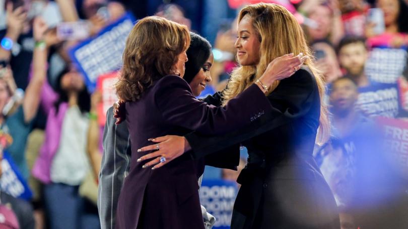 US Vice President Kamala Harris greets singer Beyonce as fellow star Kelly Roland looks on.