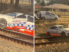 The NSW Police car ended up on train tracks near a Western Sydney station after veering off the road while attempting to intercept a motorcyclist.