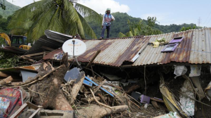 A major rescue effort is underway in the Philippines after a tropical storm caused major landslides. (AP PHOTO)