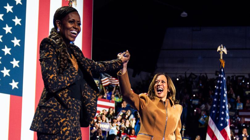 Former first lady Michelle Obama and Vice President Kamala Harris acknowledge an enthusiastic crowd in Kalamazoo, Michigan. 