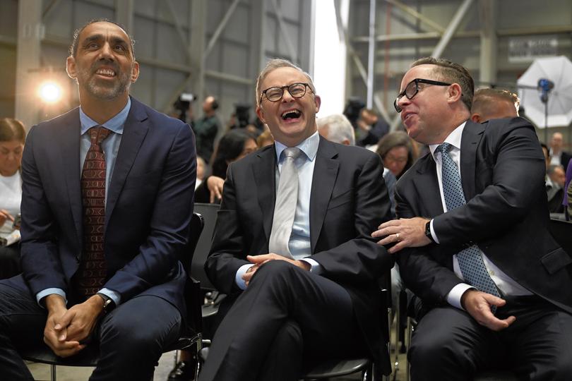 (lt-rt) Adam Goodes, Prime Minister Anthony Albanese and QANTAS CEO Alan Joyce as QANTAS unveil their Yes23 livery carried on some of their aircraft at Sydney Domestic Airport, Sydney on Monday 14 August 2023. (AAP image/Dean Lewins) NO ARCHIVING