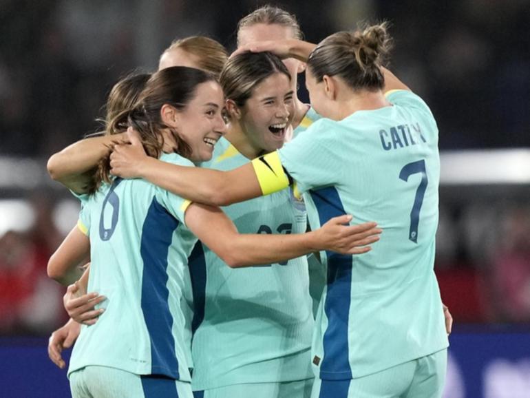 Kyra Cooney-Cross (C) is hailed by teammates after her astonishing long-range goal against Germany. (AP PHOTO)