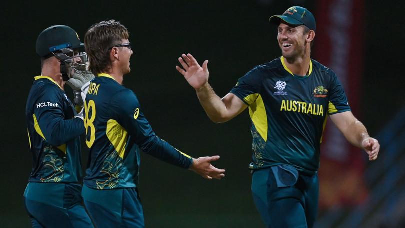 Adam Zampa celebrates with teammates Matthew Wade and Mitchell Marsh during the T20 Cricket World Cup.