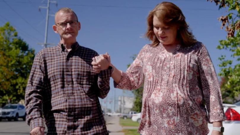 Anthony “TJ” Hoover practices walking down the street in Kentucky with help from his sister, Donna Rhorer. 