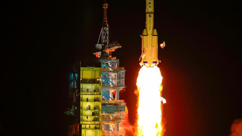 A Long March 2-F carrier rocket blasts off with China’s Shenzhou-19 crewed spaceship.