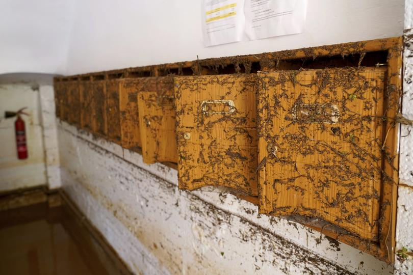 Mailboxes are photographed inside a house following floods.