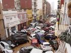 Floods of muddy water tumbled vehicles down streets amid torrential rain in Valencia, Spain. (AP PHOTO)