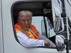 Republican presidential nominee former President Donald Trump talks to reporters as he sits in a garbage truck.