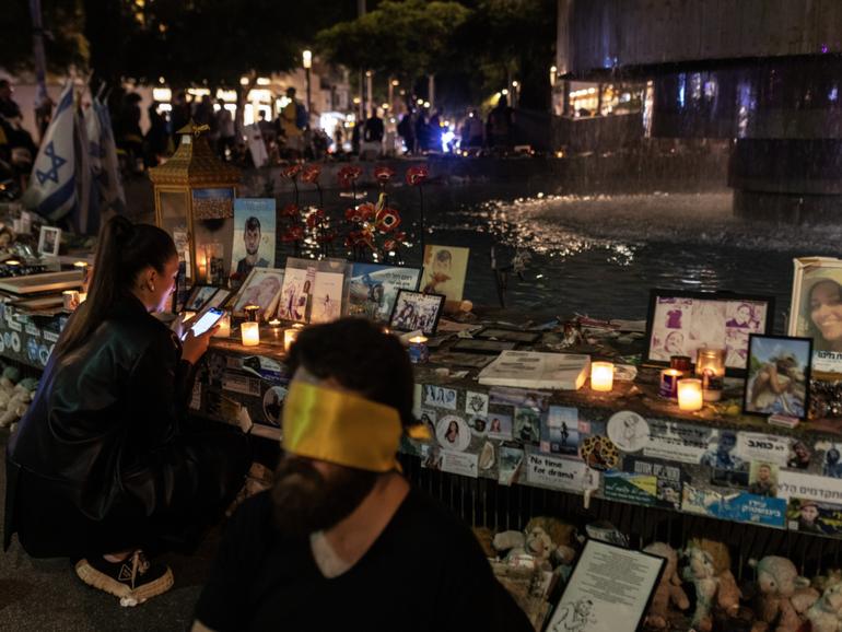 Activists, many blindfolded, demonstrate Thursday in Tel Aviv in protest of the celebration of the Jewish holiday of Simchat Torah while hostages are still held in Gaza. 