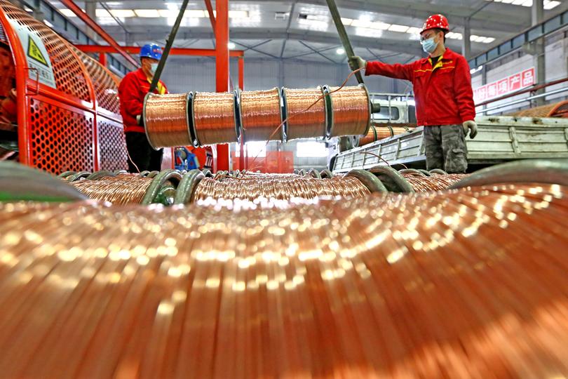 URUMQI, CHINA - NOVEMBER 15: Workers transfer copper wires at Xinjiang Euphratica Cable Manufacturing Co., Ltd on November 15, 2021 in Urumqi, Xinjiang Uygur Autonomous Region of China. (Photo by Cai Zengle/VCG via Getty Images)