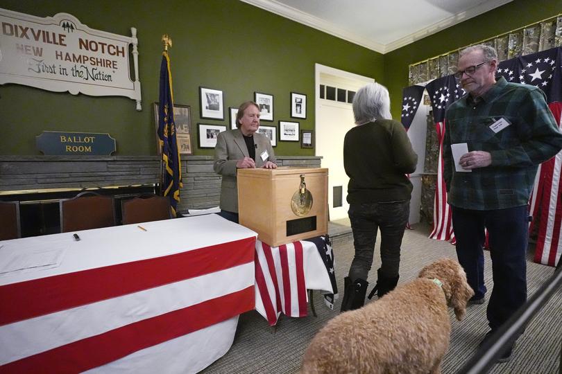 Voters cast their ballots, along with their furry friends. (AP Photo/Charles Krupa)