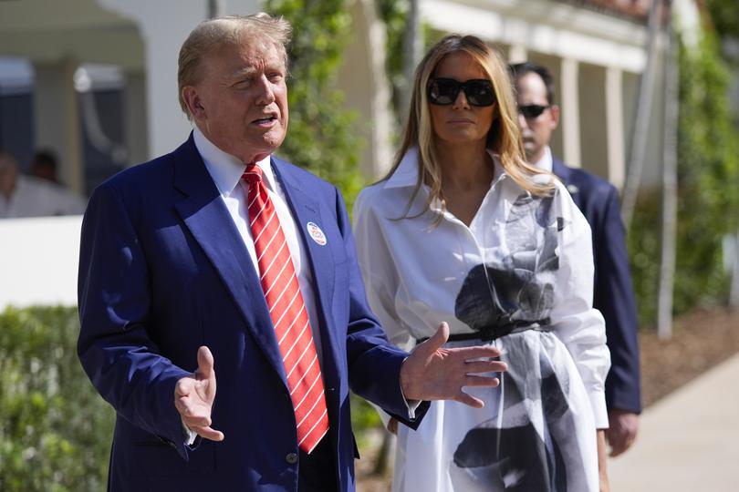 Republican presidential candidate former President Donald Trump talks as former first lady Melania Trump after casting his vote in Palm Beach. 