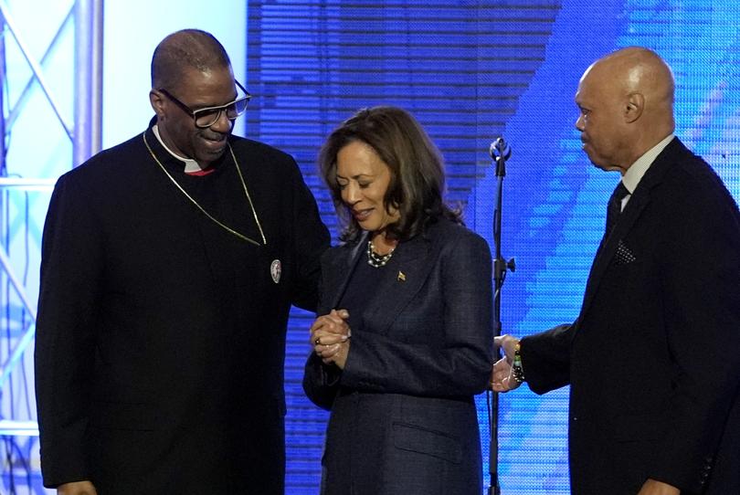 Bishop John Drew Sheard (left) leads the congregation in a prayer over Democratic presidential nominee Kamala Harris during a church service at Greater Emmanuel Institutional Church of God in Christ.