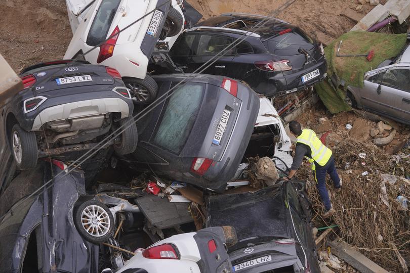 A civil guard searches for survivors in cars piled up on the outskirts of Valencia.