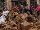 The Spanish flood mud army is out in force tackling a big clean up following a devastating disaster. (AP PHOTO)