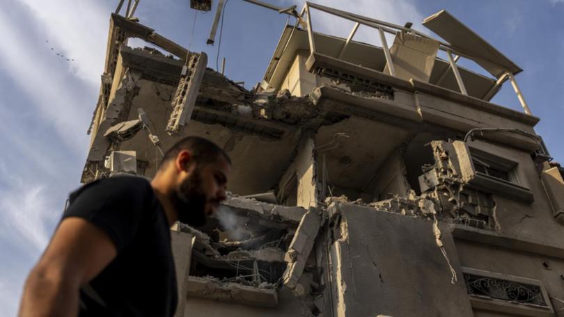 A damaged building and man walking past