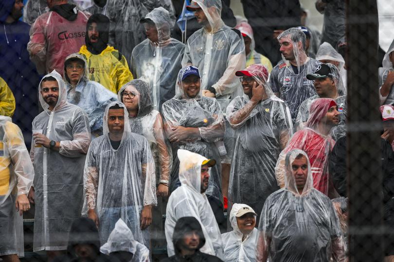 Fans waited in the rain before the qualifying event was cancelled. 