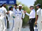 The umpire speaking with players from India A.