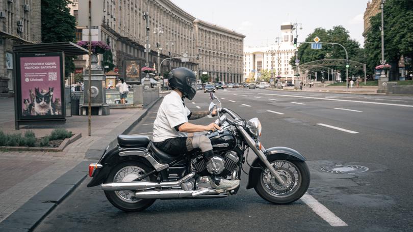 Budko rides a motorcycle in Kyiv. MUST CREDIT: Alice Martins for The Washington Post