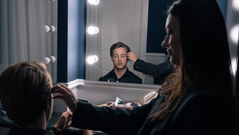 Oleksandr Teren Budko sits backstage at a filming location of The Bachelor. MUST CREDIT: Alice Martins for The Washington Post