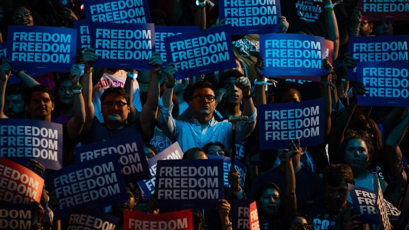 Attendees raise signs during a campaign rally for Vice President Kamala Harris, the Democratic presidential nominee, in Houston, on Oct. 25, 2024. (Damon Winter/The New York Times)