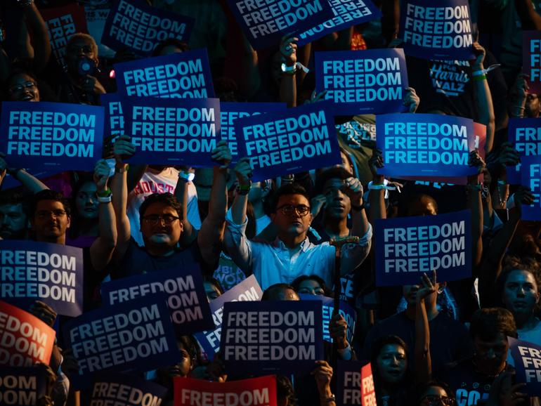 Attendees raise signs during a campaign rally for Vice President Kamala Harris, the Democratic presidential nominee, in Houston, on Oct. 25, 2024. (Damon Winter/The New York Times)