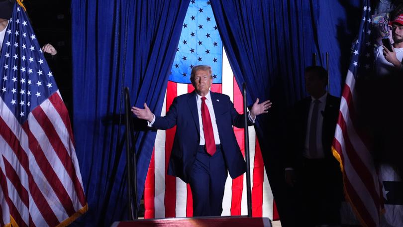 Former president Donald Trump enters a rally in Atlanta on Oct. 28. 