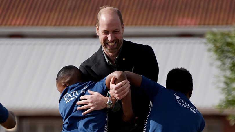 Prince William takes part in a rugby coaching session with local school children during a visit to Ocean View Secondary School in Cape Town, South Africa.