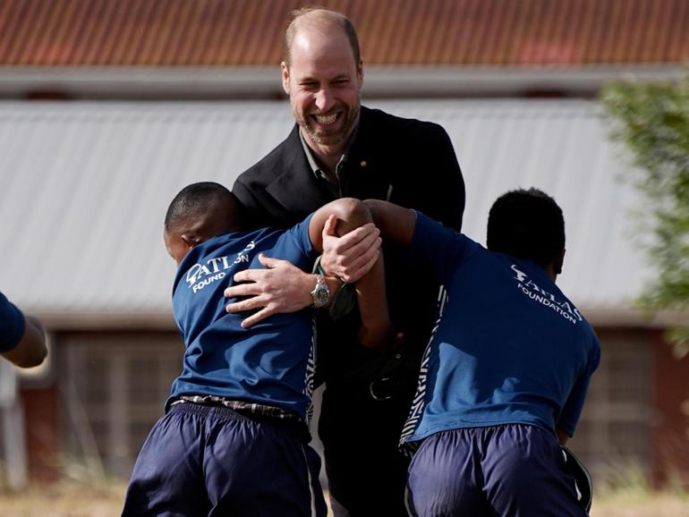 Prince William takes part in a rugby coaching session with local school children during a visit to Ocean View Secondary School in Cape Town, South Africa. 