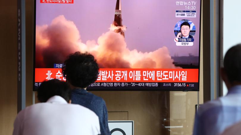 People watch a TV showing a file image of a North Korean missile launch in Seoul in 2021.