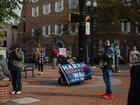 Douglas Wickenheiser, 67, holds a flag in support of the Harris-Walz ticket in downtown Lancaster, Pennsylvania on Oct. 26. 