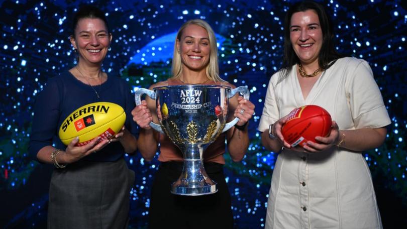 Launching the AFLW finals series are (from left) Emma Moore, Erin Phillips and Laura Kane.  (James Ross/AAP PHOTOS)