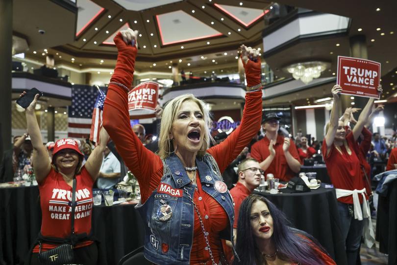 People react to election results showing US Republican presidential candidate Donald J. Trump’s lead in the state of Nevada during the Nevada Republican Party watch party. 