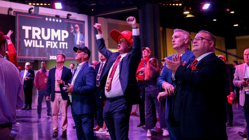 Attendees react as 2024 US Presidential election results are broadcast at the Palm Beach Convention Centre.